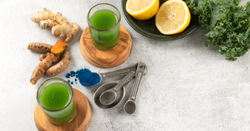 two servings of clean green juice shot on a table