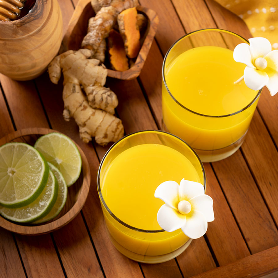 jamu juice ginger turmeric drink with flower garnish